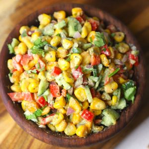 aerial shot of creamy corn salad in a wooden bowl.