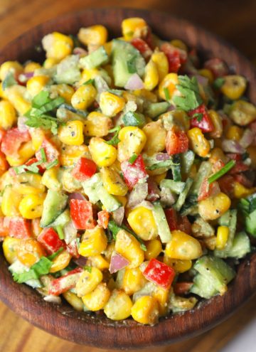 aerial shot of creamy corn salad in a wooden bowl.