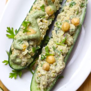 side shot of cucumber boats served on a white ceramic plate.