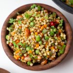aerial shot of jowar upma served in a wooden bowl.