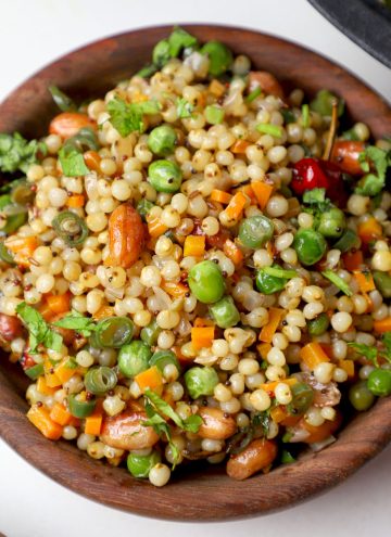 aerial shot of jowar upma served in a wooden bowl.