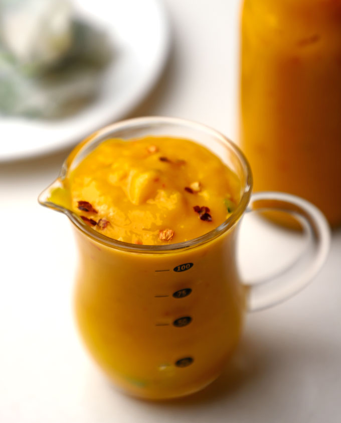 side close up shot of mango chilli sauce in a glass jar.
