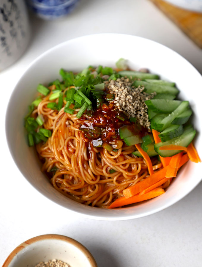 side close up shot of Bibim Guksu served in a white ceramic bowl.