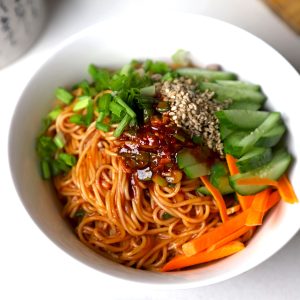 side close up shot of vegan Bibim Guksu served in a white bowl.