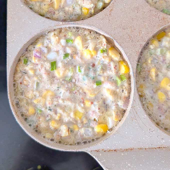 cooking corn fritters in a pan.
