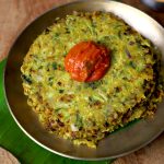 side close up shot of jowar thalipeeth served with chutney in a kansa plate.