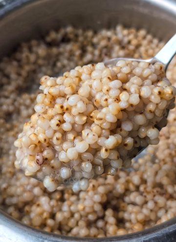 side close up shot of cooked whole jowar in a pressure cooker.