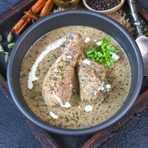 aerial shot of chicken kali mirch served in a black bowl.