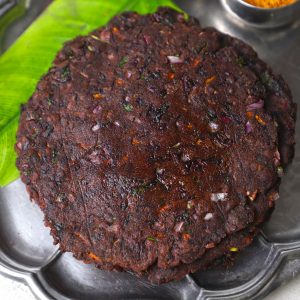 side aerial shot of ragi adai stacked in a stainless steel platter.