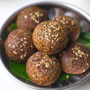 side close up shot of ragi appe stacked on a steel bowl.