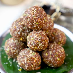 side close up shot of ragi laddu stacked on a banana leaf.