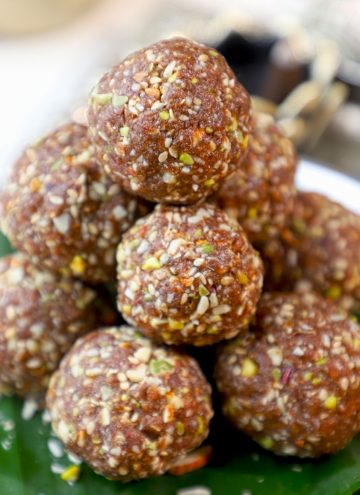 side close up shot of ragi laddu stacked on a banana leaf.