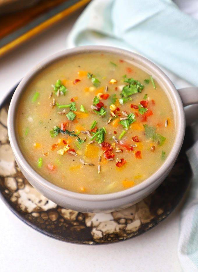 aerial shot of low calorie jowar soup served in a bowl.
